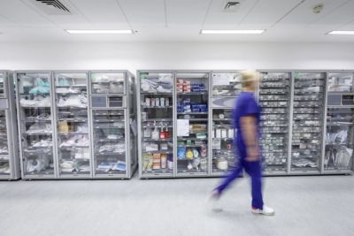 Hospital storage area with organized medical supplies and equipment in transparent cabinets