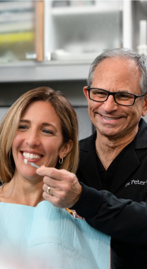 Dental professional showing the results of tooth whitening