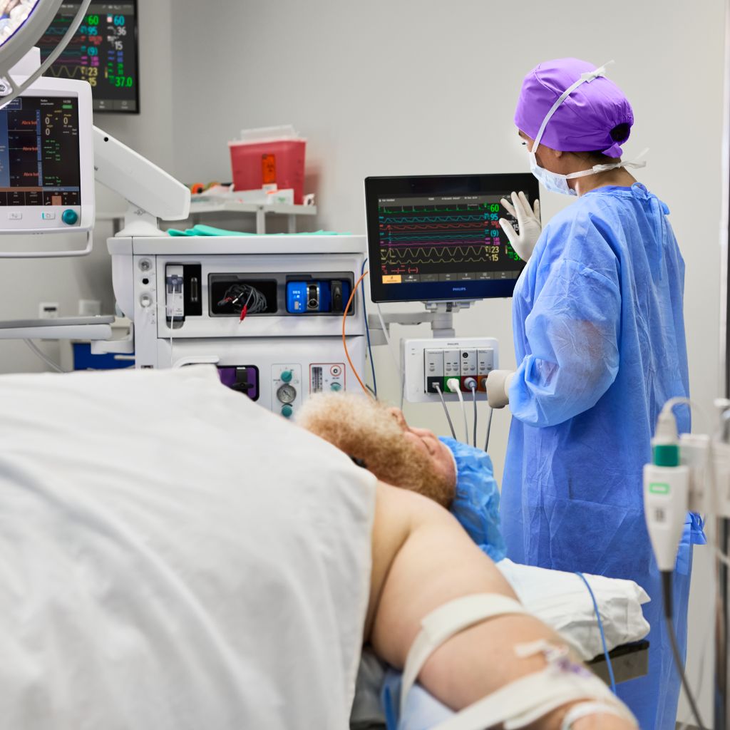 nurse touching monitor screen