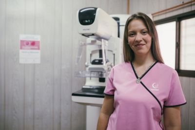 Mamotest technologist standing beside a mammography system supported by Philips Foundation