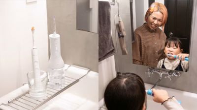 電動歯ブラシを使って親と一緒に歯を磨く子供