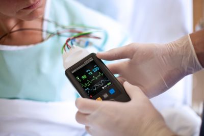 Portable cardiac monitor in use during patient examination