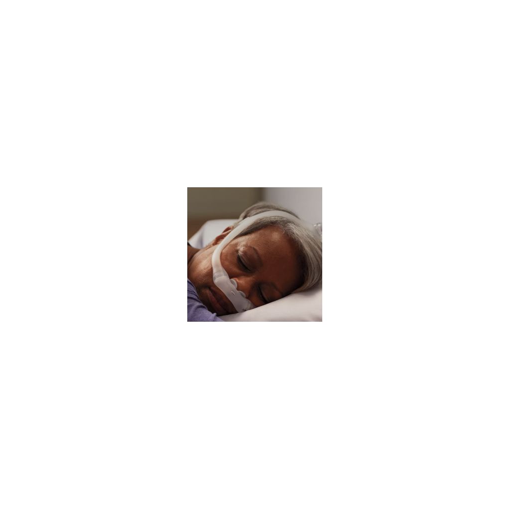 A women sleeping comfortably wearing a CPAP mask