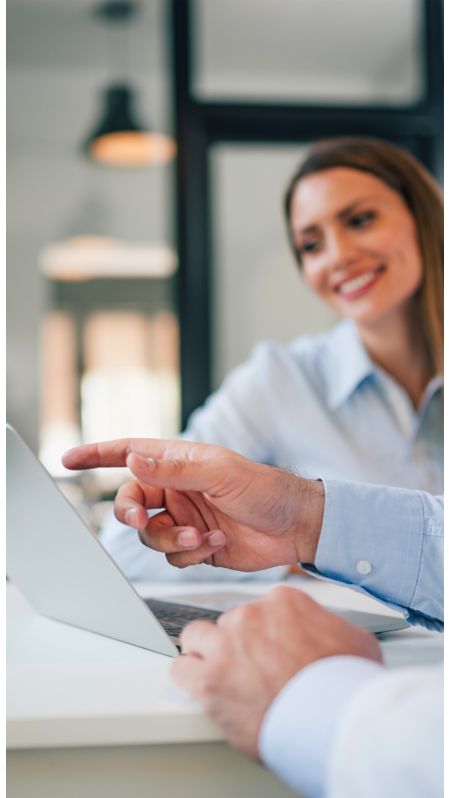 Hand pointing to a laptop screen