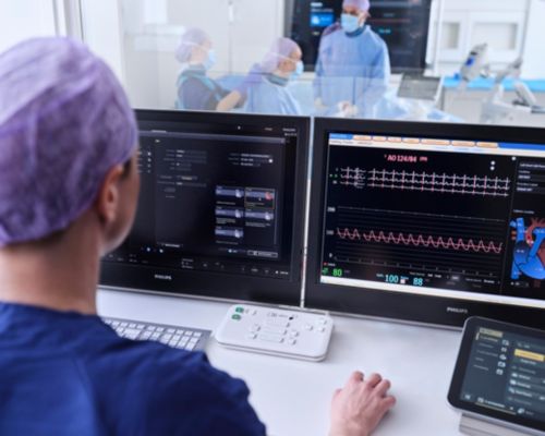 A clinician accesses information while physicians care for a patient