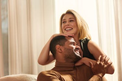 Couple smiling together in natural light promoting oral healthcare lifestyle