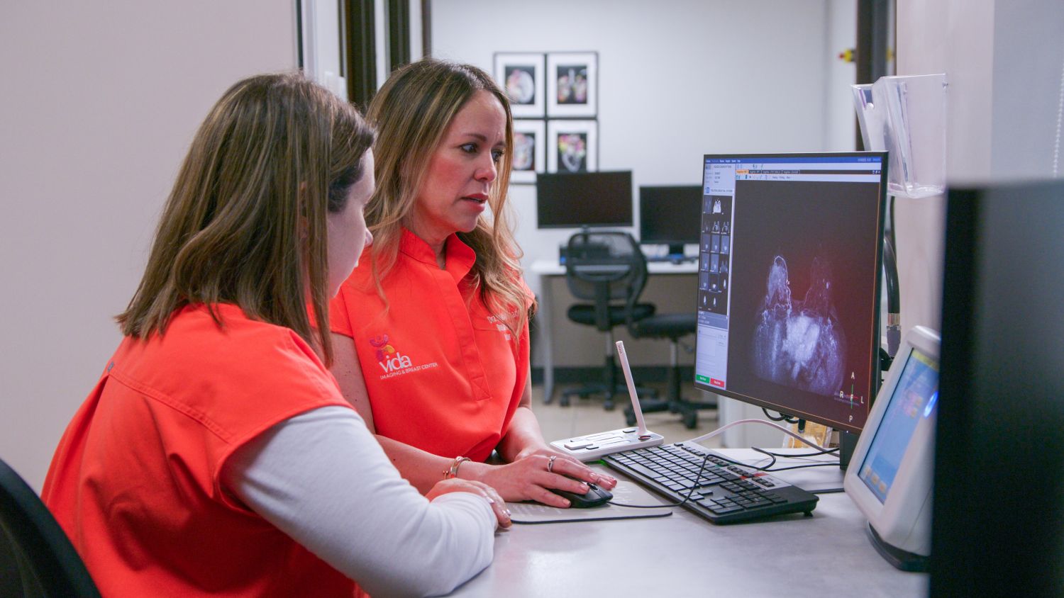 Dr. Mayra Maldonado in front of the MRI system
