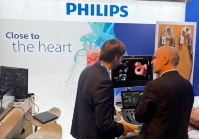 Cardiology professionals reviewing cardiac ultrasound imaging at medical congress