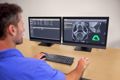 Clinician using Philips DynaCAD Urology software with advanced annotation tools on dual monitors