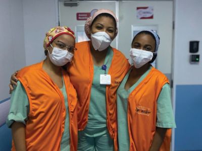 Healthcare professionals from SAS Brasil wearing protective masks in hospital corridor