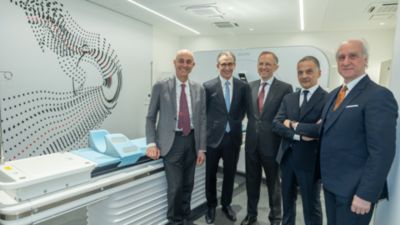 Five representatives beside a Philips CT system at the Ferrari Med Ex diagnostic centre