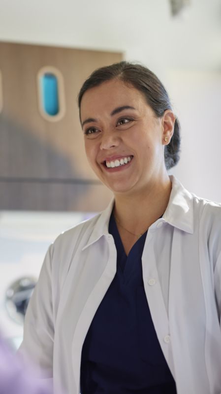 A dental professional speaks to a patient