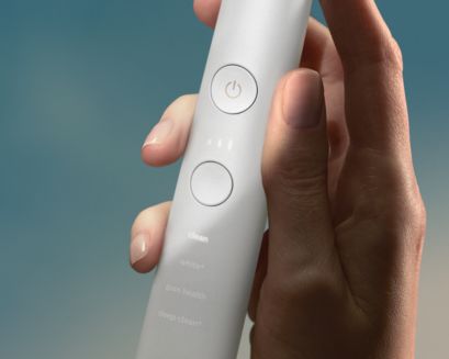A hand holding a Philips Sonicare DiamondClean Smart handle.