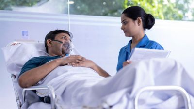 Nurse attending to patient with oxygen mask