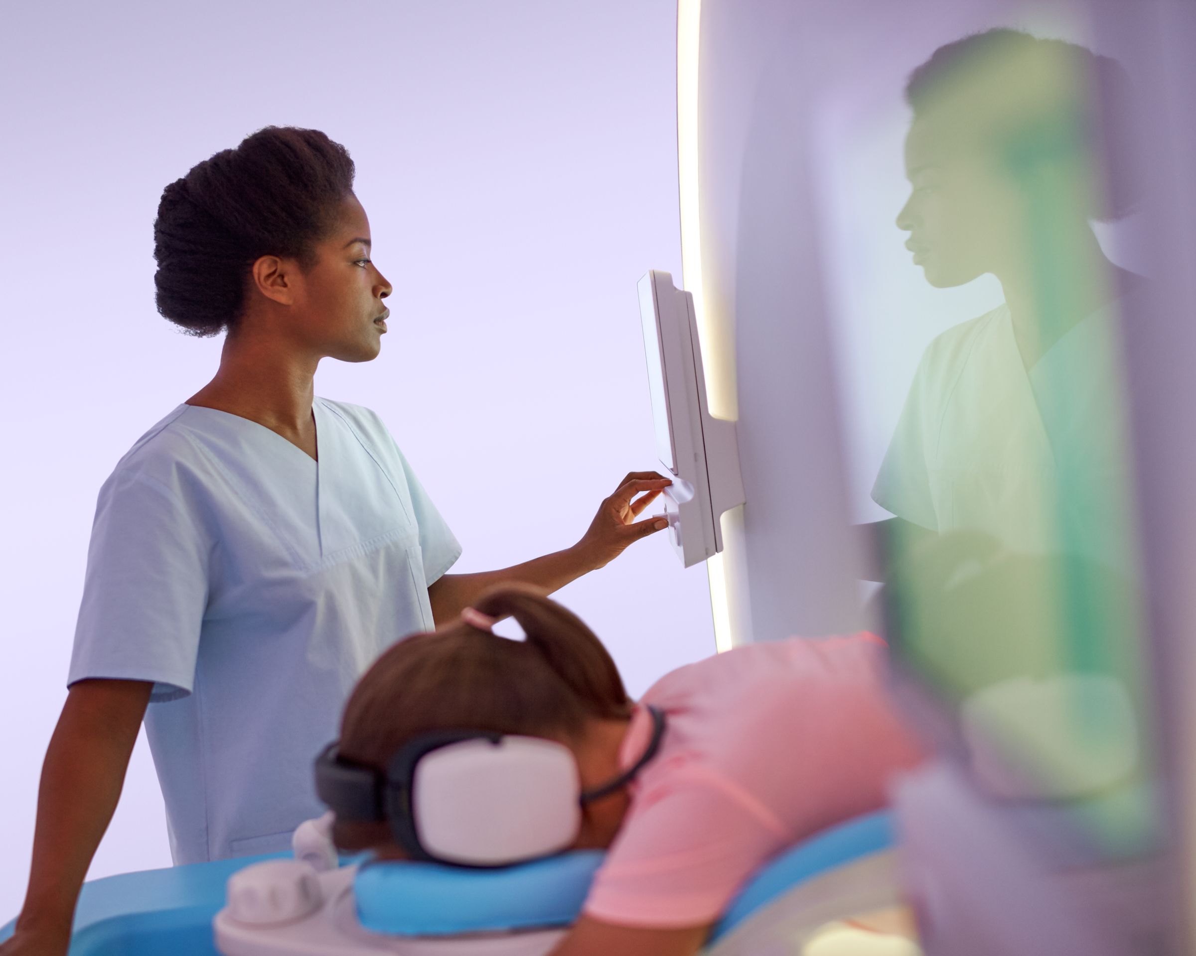 Technologist preparing a patient for an MRI exam