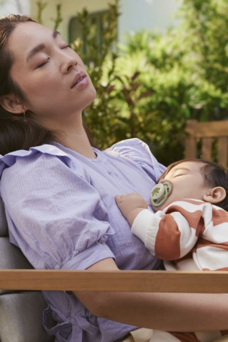 A mother holding his baby