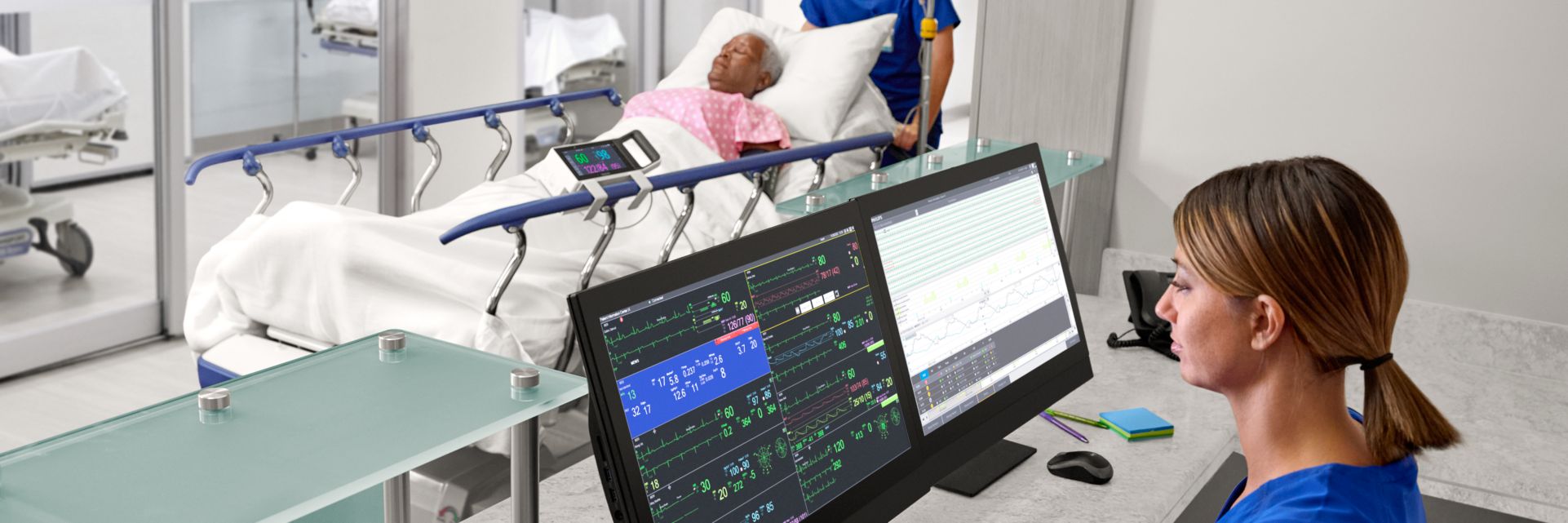 patient being rolled down hallway while nurse monitors