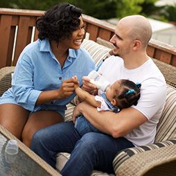 Couple feeding baby