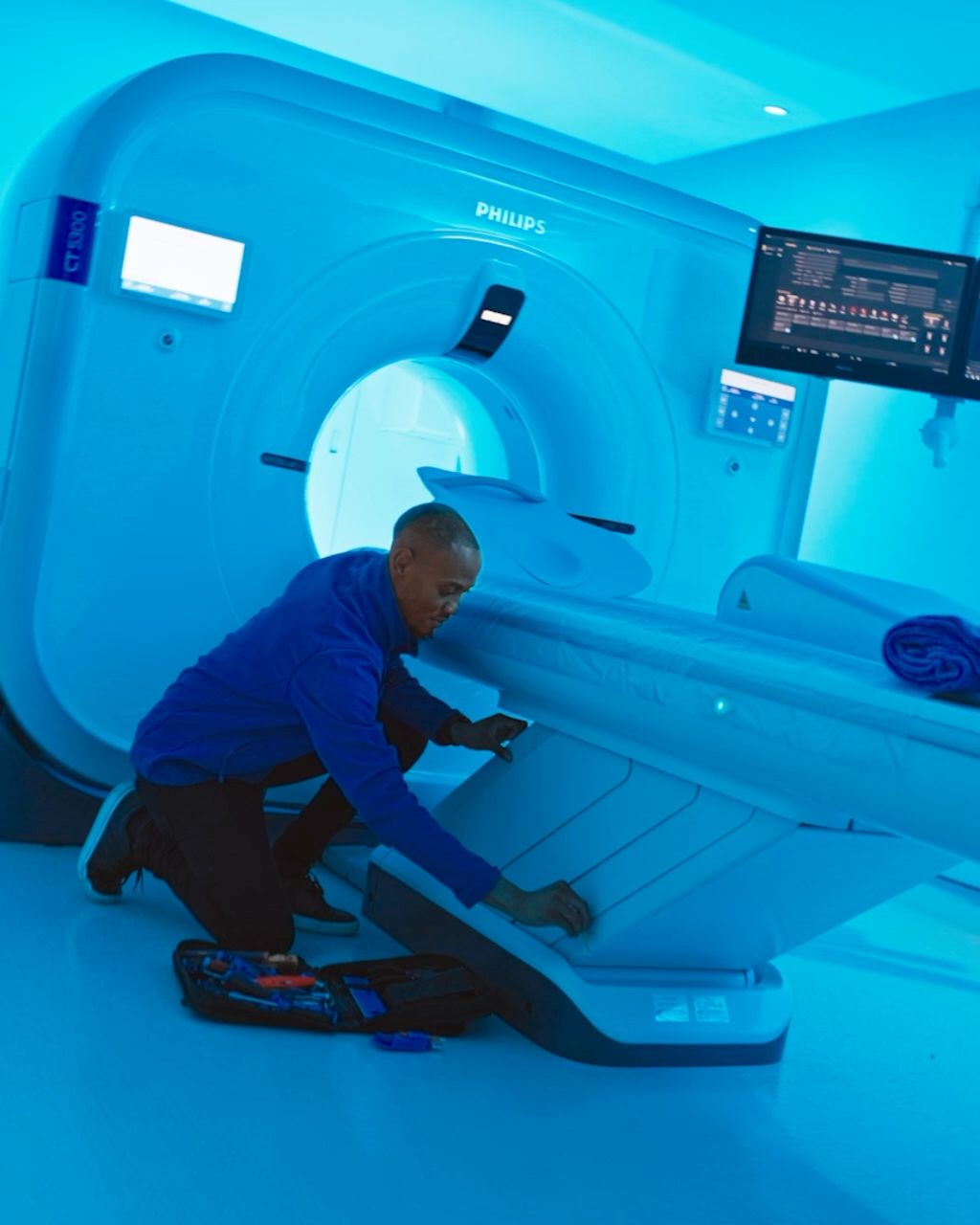 Service engineers performing maintenance on CT scanner