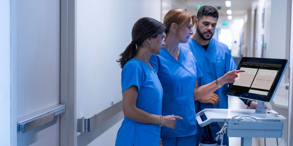 Doctor and hospital staff reviewing Cardiac Workstation ECG