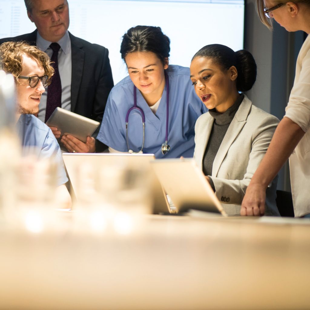 IT, nurse, doctor in hallway with tablet