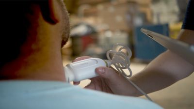 A nurse conducting a mobile ultrasound scan on a patient