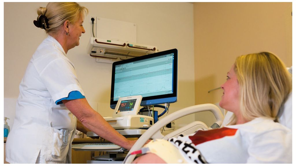 Staff in a room with patient using Intellispace Perinatal