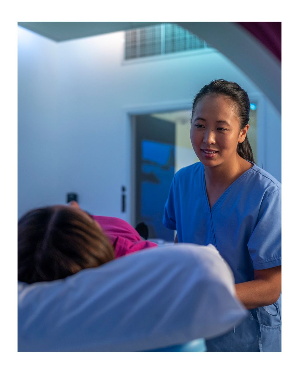 Female tech with patient in ct scanner