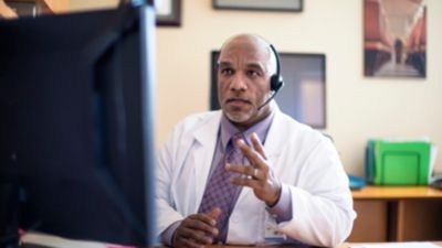 Physician conducting virtual consultation using connected care technology