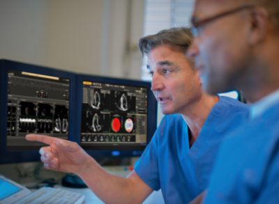 Cardiologists reviewing imaging and patient data using Philips IntelliSpace Cardiovascular system