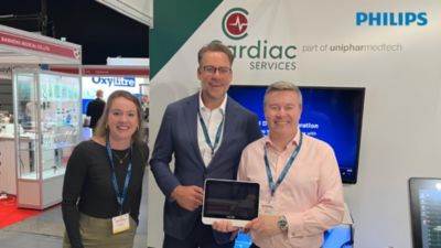 Philips and Cardiac Services representatives at trade show announcing UK reseller partnership for medical device integration