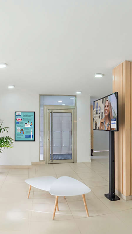 A waiting room in a dental practice with marketing materials