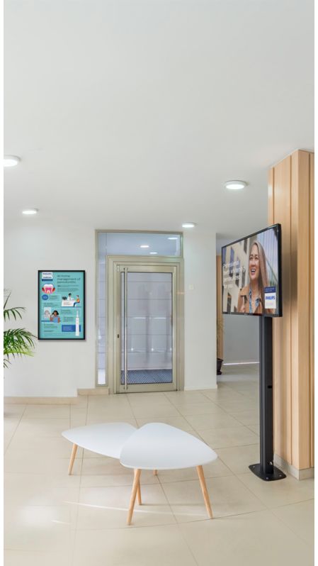 A waiting room in a dental practice with marketing materials