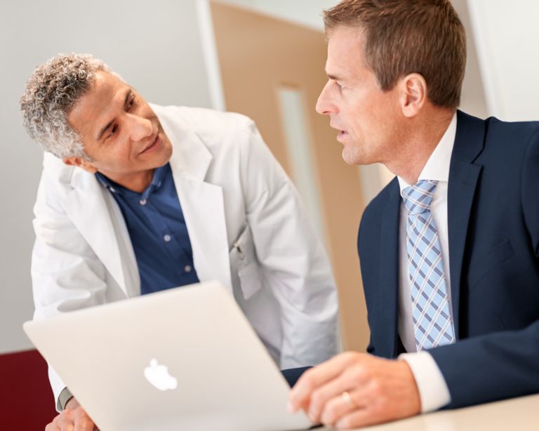 Clinician and c-suite discussing informatics service agreements