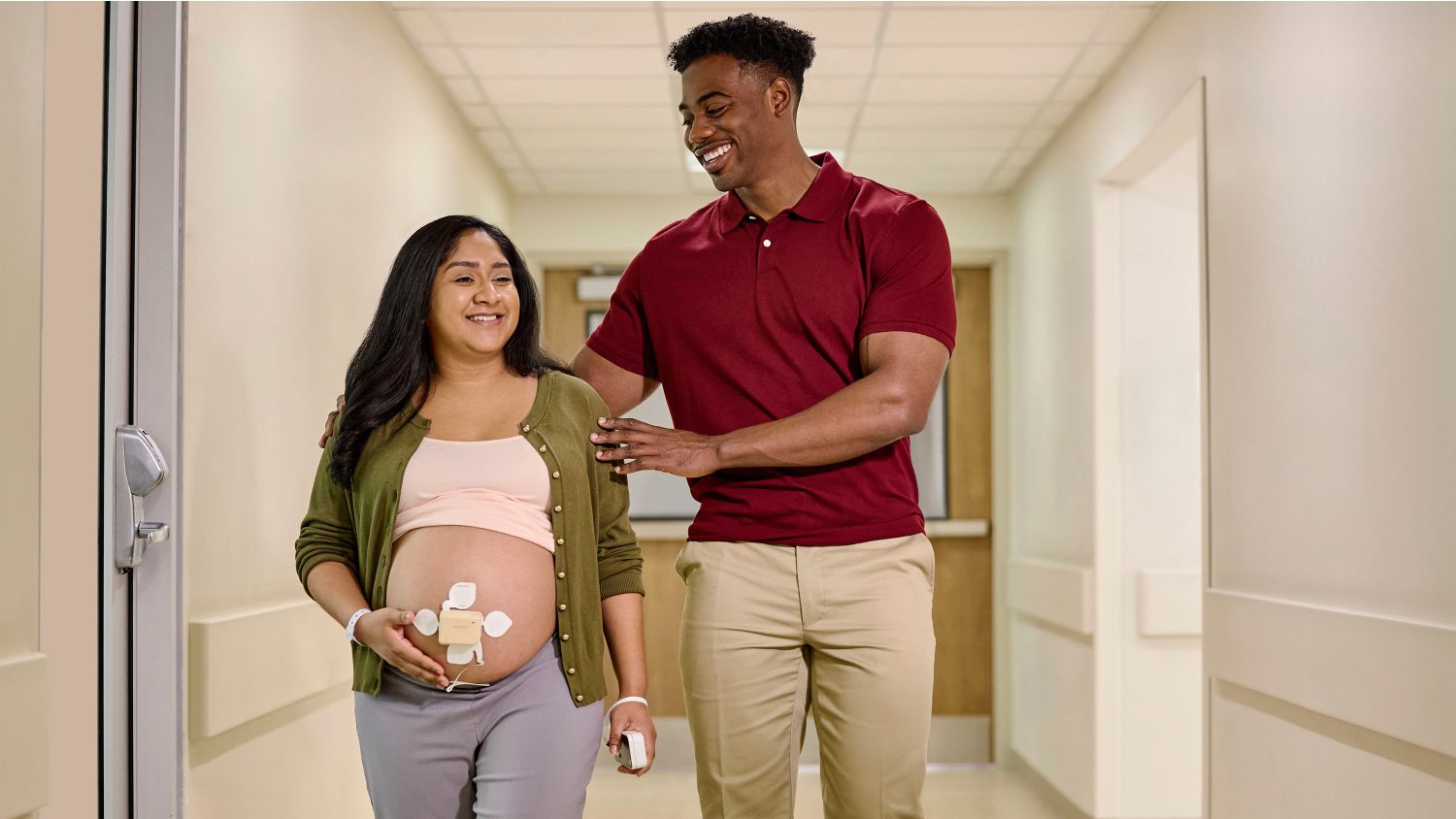 pregnant patient wearing Philips Avalon beltless fetal monitor walking with partner