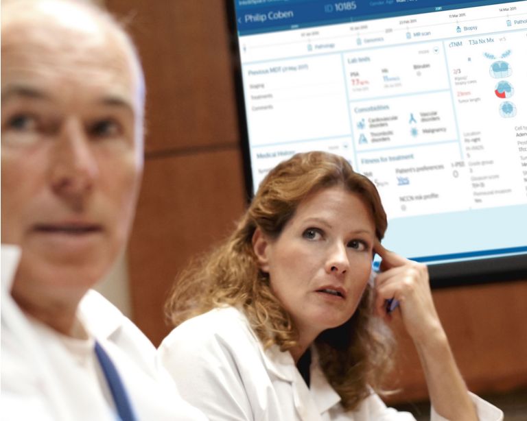 male and female medical professionals looking at a screen