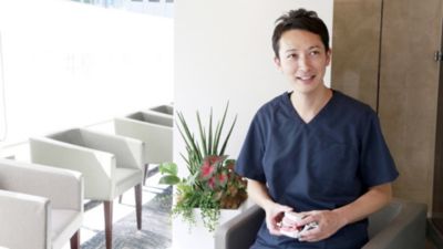 歯科模型を持った診療所に座っている歯科医