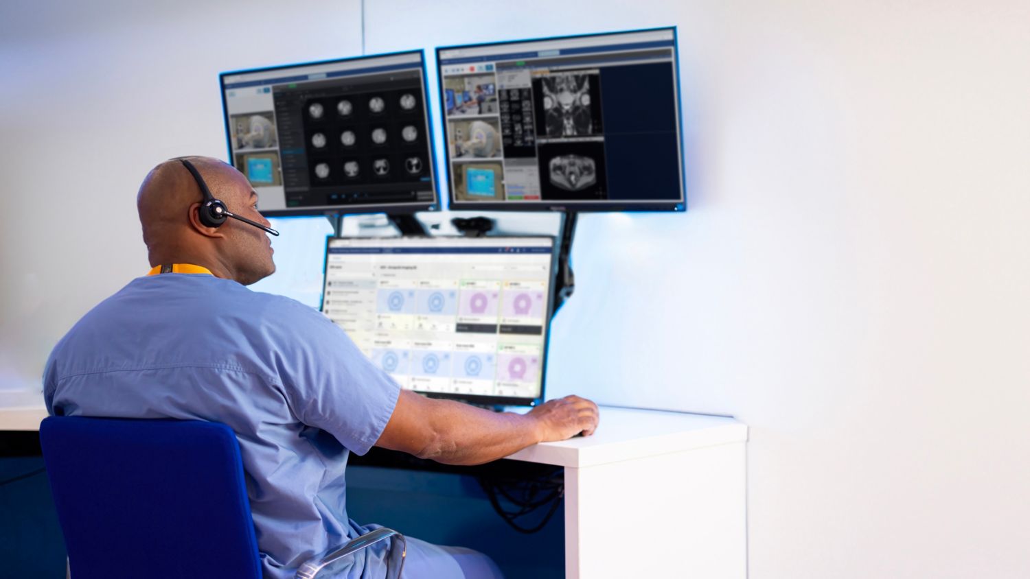 technician looking at radiology operations command center screen