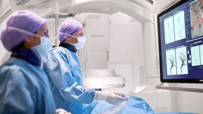 Clinicians performing image-guided procedure with Philips Azurion system
