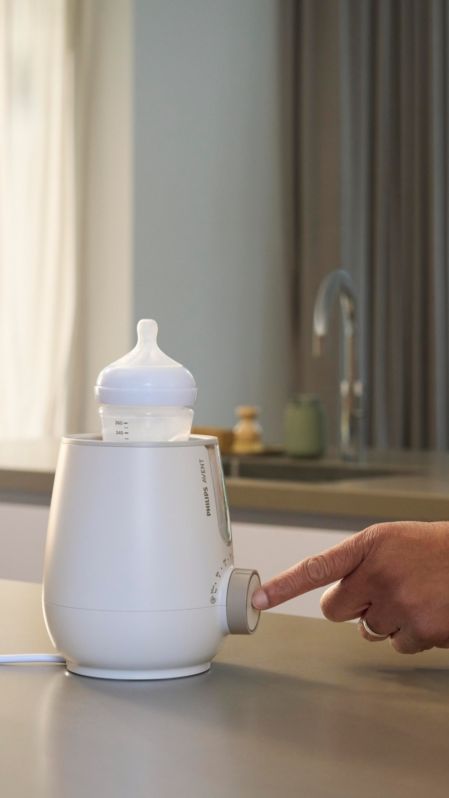 Parent using Premium 2-in-1 Warmer & Sterilizer