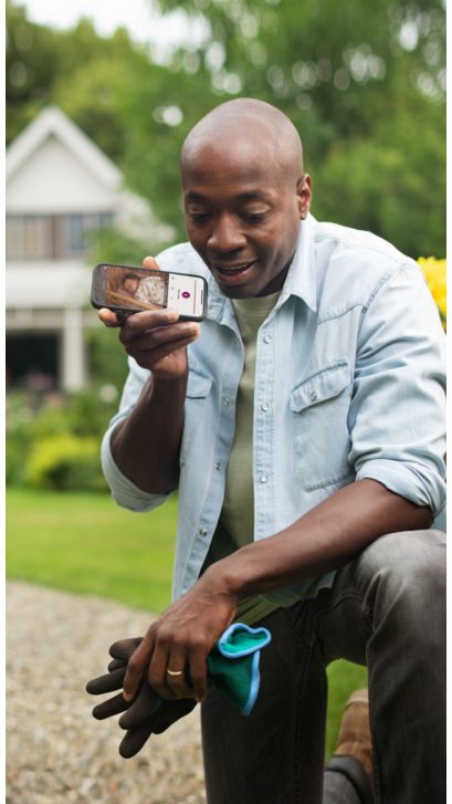 Man talking to his baby via a phone