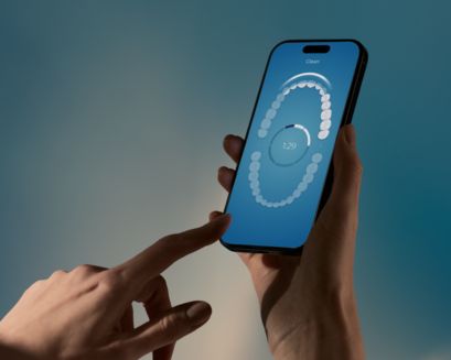 A phone showing the Philips Sonicare app in use.