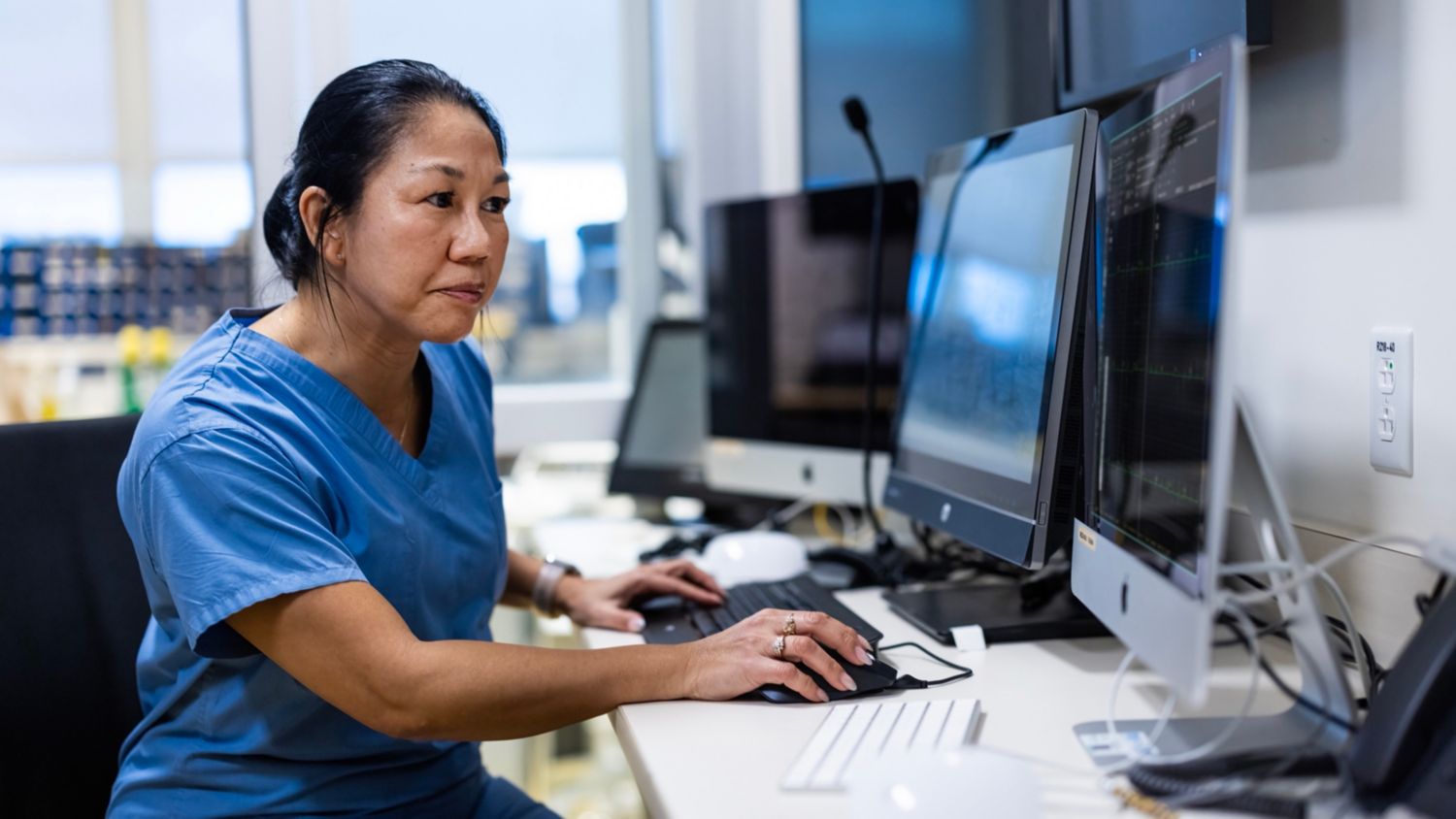 Healthcare provider looking at monitor screen