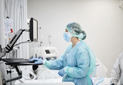 Nurse using clinical workstation in hospital care setting