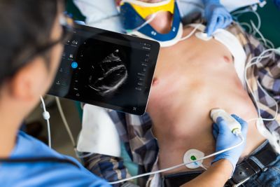 Clinician performing cardiac ultrasound with handheld device
