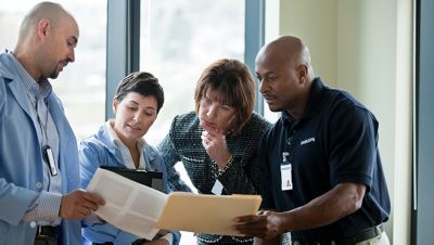 Healthcare professionals reviewing documents together in collaborative discussion