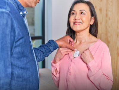 Healthcare professional applying Philips wearable biosensor on a patient’s chest