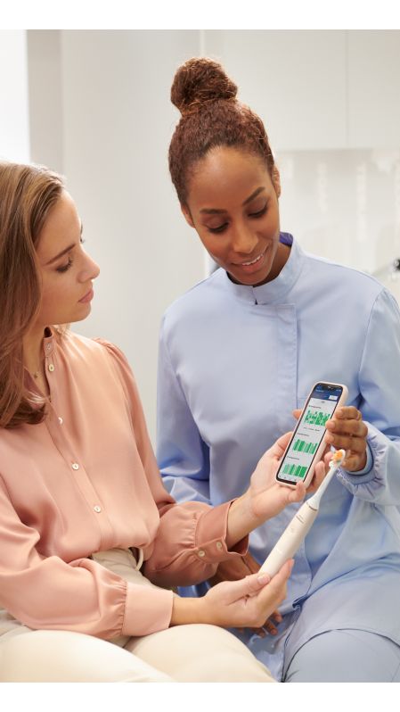 Dental professional showing how to brush Sonicare power.