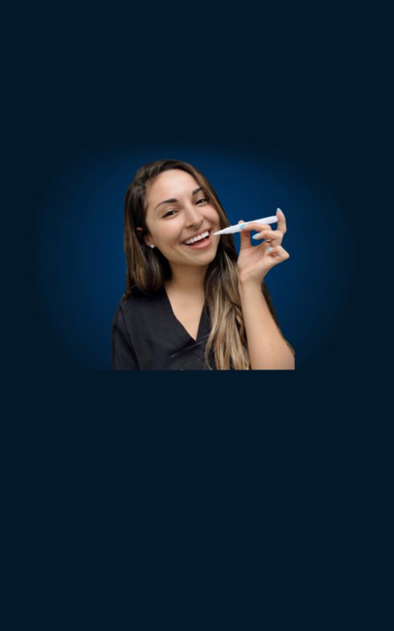 A dentist, Dr. Tania Ramezani, DDS, about to apply
