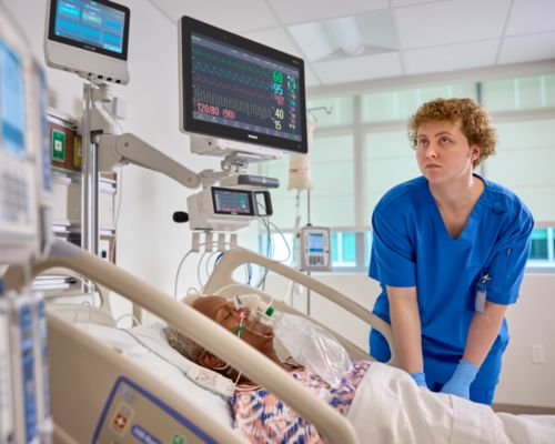 Nurse caring for female patient in ICU, Neuron on wall